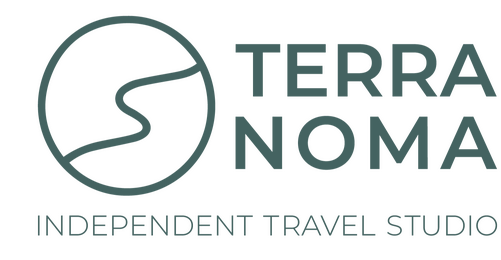 Terra Noma logo with refined olive-toned wordmark and minimalist path symbol, representing thoughtful, grounded travel design